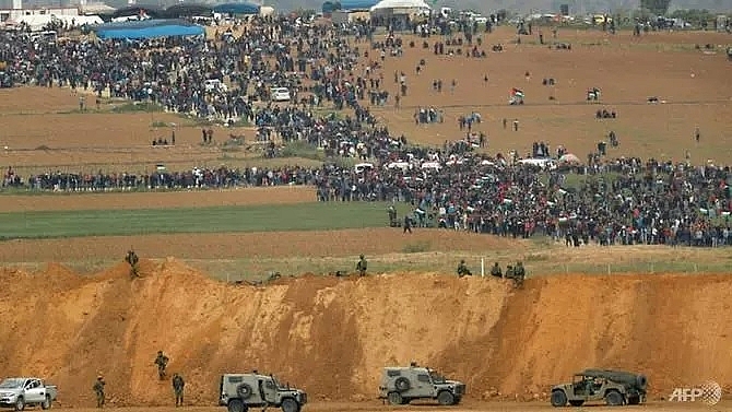 four killed as thousands protest at border but gaza israel truce holds
