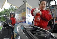 Motorcyclists fill up at a petrol station in Taipei last month. The Taiwanese government announced Sunday the end of a fuel subsidy that had been in place 16 months, pushing up petrol prices by around 10 percent and drawing condemnation from opposition parties