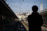 People wait for a train at Cais do Sodre train station in Lisbon. The International Monetary Fund said Wednesday Portugal was making 