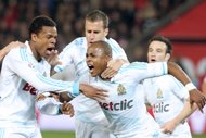 Marseille's Ghanaian forward Andre Ayew (C) celebrates after scoring a goal during the French L1 football match Paris vs Marseille, at the Parc des Princes stadium in Paris. Paris Saint Germain rekindled hopes of a first French league championship success in 18 years on Sunday after squeezing past old rivals Marseille 2-1 at the Parc des Princes.