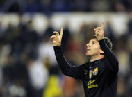 Barcelona's Argentinian forward Lionel Messi celebrates after scoring during the Spanish League football match between Real Zaragoza and FC Barcelona on April 7, at La Romareda stadium in Zaragoza. A midweek programme brings no respite to the battle for La Liga, as Barcelona entertain Getafe on Tuesday while leaders Real Madrid make the short trip to city rivals Atletico on Wednesday. (AFP Photo/Lluis Gene)