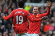 Manchester United forward Wayne Rooney (R) celebrates after scoring with Danny Welbeck during an April 22 match. Team manager Sir Alex Ferguson believes the strike pair could emulate the Old Tafford goal-scoring havoc once wreaked by Dwight Yorke and Andy Cole.