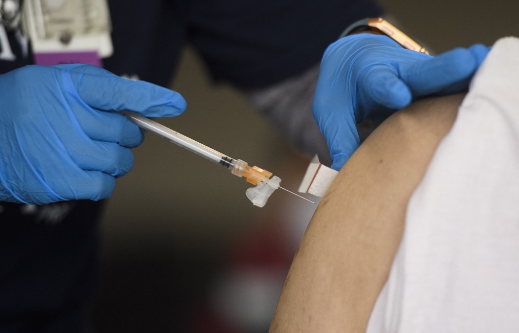 US hits vaccine milestone as NZealand, Australia open travel bubble