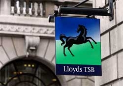 British bank Lloyds tumbles back into red