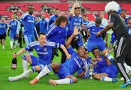 Chelsea's players celebrate on the pitch with the trophy after Chelsea's 2-1 win in the FA Cup final match against Liverpool at Wembley Stadium in London, on May 5. Didier Drogba and John Terry made history as Chelsea withstood a late Liverpool onslaught to seal their fourth FA Cup final victory in six seasons with a 2-1 win.
