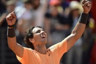 Rafael Nadal wins his sixth Rome Masters title in a rain-postponed final against Novak Djokovic here on Monday, defeating the world number one 7-5, 6-3. (AFP Photo/Filippo Monteforte)