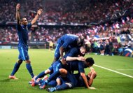 French defender Adil Rami (C) is congratulated by teammates after scoring a goal during the friendly football match France vs Iceland at the Hainaut Stadium in the French northern city of Valenciennes. (AFP Photo/Franck Fife)