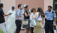 Foreign women talk to a policeman outside Doha's Villagio Mall after a fire broke out at the Gulf emirate's main shopping centre on May 28, 2012, killing at least 19 people, including 13 children. (AFP Photo/)