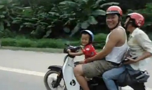 5 year old boy drives motorbike carrying 2 adults