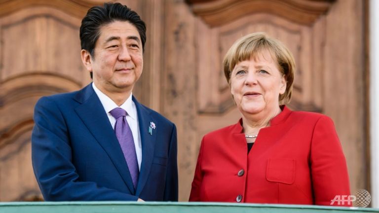 merkel abe differ on how to fix world economy