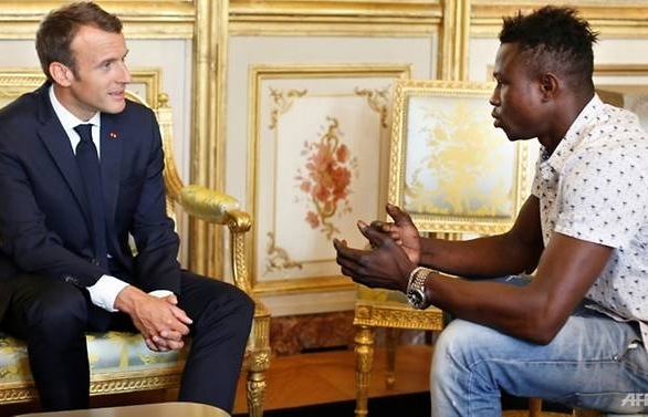 migrant spiderman who saved child praised by frances macron