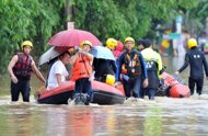 Rescuers drag rafts to evacuate people in Tucheng area of New Taipei City, on June 12. At least four people have died and one was injured when mudslides triggered by torrential rains hit two areas in central Taiwan, acccording to rescue officials