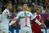 Portuguese forward Cristiano Ronaldo (C) during the Euro 2012 match against Denmark on June 13. He has yet to score in the tournament and a succession of missed chances in the 3-2 win over Denmark ended with Danish fans chanting 'Messi! Messi!'. (AFP Photo/Damien Meyer)