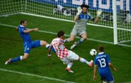Croatian forward Mario Mandzukic (C) scores past Italian goalkeeper Gianluigi Buffon (top) during a Euro 2012 championships football match at the Municipal Stadium in Poznan. Mandzukic's third goal of Euro 2012 saw Croatia come from behind to draw 1-1 with Italy in their Group C match here on Thursday. 