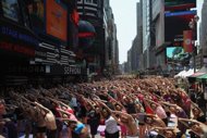 Thousands of yoga fans take over Times Square