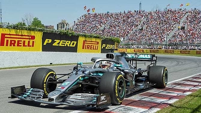 hamilton takes controversial canada win after vettel penalised
