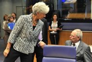 International Monetary Fund Managing Director Christine Lagarde (L) and German Finance Minister Wolfgang Schauble talk prior to a Eurozone Council meeting June 21. Lagarde on Friday hailed recent 