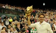Roger Federer celebrates with the trophy after his men's singles final victory over Britain's Andy Murray on Day 13 of the 2012 Wimbledon Championships at the All England Tennis Club in southwest London, on July 8. Federer won the match 4-6, 7-5, 6-3, 6-4. (AFP Photo/Leon Neal)