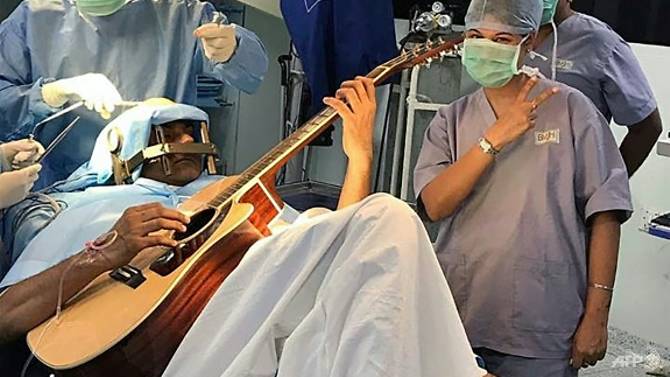 Indian man who played guitar during brain surgery makes recovery
