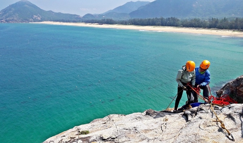 Outward Bound Vietnam instructors doing safety checks with equipment and participants
