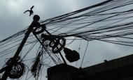 A bird lands on an electric pole wrapped with wires in Kolkata. An area stretching from the western border with Pakistan to the far northeastern state of Arunachal Pradesh next to China is affected by a massive power cut, with the huge cities of New Delhi, Kolkata and Lucknow suffering without supplies