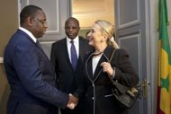 US Secretary of State Hillary Clinton (R) meets with Senegal's President Macky Sall at the Presidential Palace in Dakar, Senegal. Clinton hailed Senegal as a democratic beacon in Africa Wednesday as she began an 11-day whirl around the continent that will focus on peace, security and development. (AFP Photo/Jacquelyn Martin)