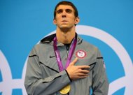 Gold medalist US swimmer Michael Phelps listens to his national anthem on the podium after winning the men's 200m individual medley swimming event at the London 2012 Olympic Games in London. (AFP Photo/Christophe Simon)