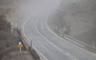 State Highway 1 sits in a cloud of ash after the eruption of Mount Tongariro in the Tongariro National Park on August 7, 2012. The New Zealand volcano erupted unexpectedly late on August 6 after lying dormant for more than a century, spewing an ash plume that disrupted flights and closed highways, officials said