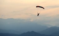 A skydiver is seen in Colombia on August 8. A New Zealand skydiver was lucky to be alive after a jump from 4,000 metres (13,000 feet) went wrong, thanks to swampy ground cushioning the impact of his landing, reports said Friday. (AFP Photo/Luis Robayo)