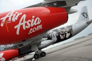 Low cost carrier AirAsia Tuesday said its second-quarter net profit surged more than 10 times from a year earlier due to a one-time gain with the listing of Asia Aviation PCL