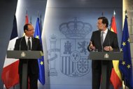 Spanish Prime Minister Mariano Rajoy (R) and French President Francois Hollande give a press conference after their meeting at the Moncloa Palace in Madrid. France and Spain united Thursday in calling for decisive eurozone action to curb crippling borrowing rates, which threaten to push Madrid into seeking a full bailout. (AFP Photo/Dominique Faget)