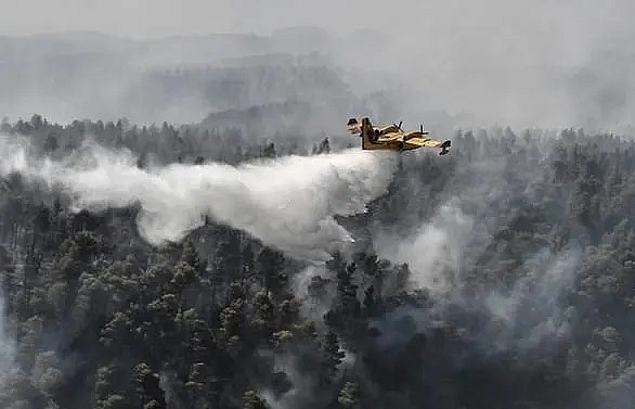 EU water bombers join Greek firemen to douse island wildfire