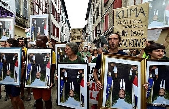 Anti-G7 activists march with 'stolen' Macron portraits
