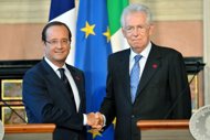 French President Francois Hollande (L) shakes hands with Italian Prime Minister Mario Monti during a joint press conference following their meeting at the Villa Madama in Rome. Monti called Tuesday on the European Union to recognise efforts made by countries to overcome the economic crisis by moving to bring down punishing borrowing costs. (AFP Photo/Andreas Solaro)