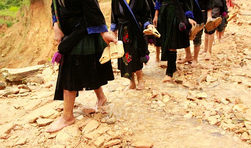 Vietnamese kids walk through a stream to school.<br /><span>Truong Cong Thanh</span>
