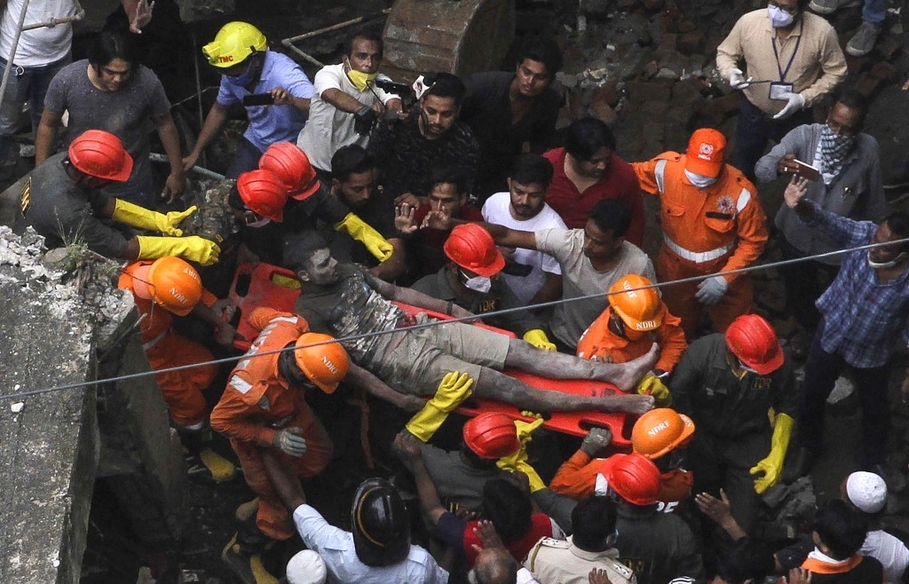 ten dead up to 25 feared trapped in india building collapse