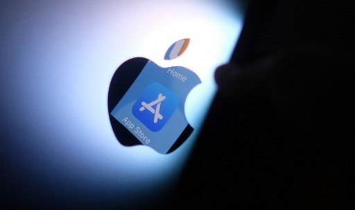 This file illustration photo shows the Apple app store logo reflected from an iPhone onto the back of an iMac in Los Angeles, August 26, 2021. A US judge on September 10, 2021 ordered Apple to loosen control of its App Store, barring it from obliging developers to use its payments system, in a high-profile antitrust case brought by Fortnite maker Epic Games. Chris DELMAS / AFP