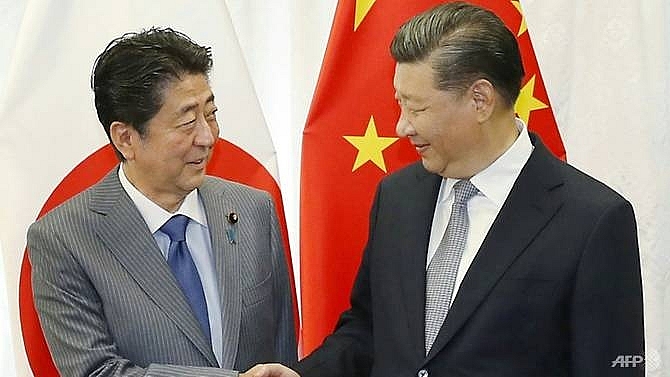 japans abe to make rare china visit as relations thaw