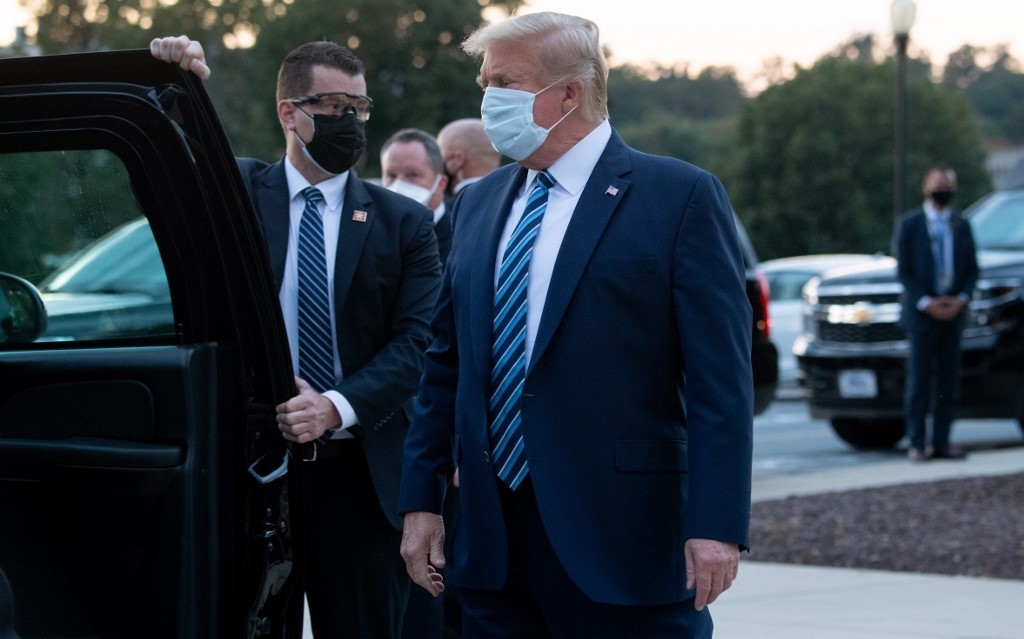 trump leaves hospital for white house removes mask immediately