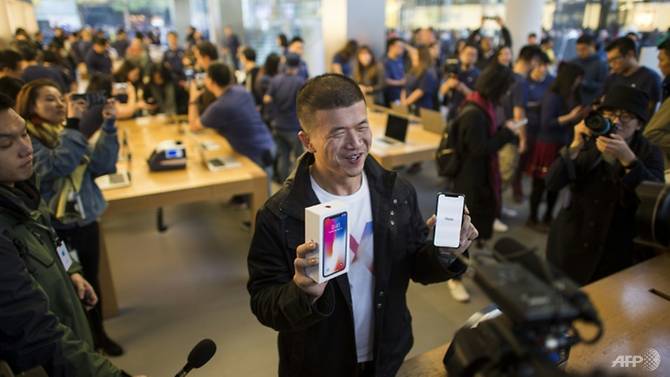 fans throng apple stores across asia for launch of iphone x