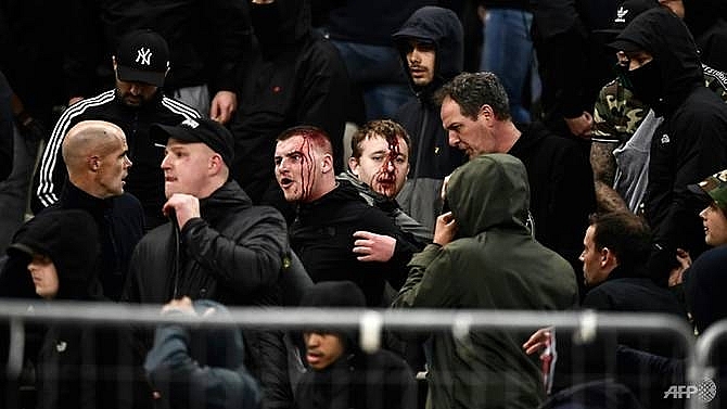 ajax fans injured in violence hit athens champions league match