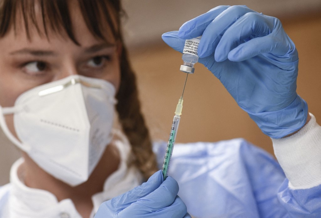 Medical personal fills a syringe with the Biontech Pfizer vaccine in a vaccination station at the Stephanus church in Stuttgart, southern Germany, on November 16, 2021, amid the ongoing coronavirus pandemic. THOMAS KIENZLE / AFP