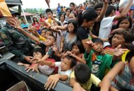 Evacuees queue up to receive food aid from government officials in Iligan City, in southern island of Mindanao after Typhoon Washi wrought havoc in the city. The civil defence agency said that more than 348,000 people were affected by the storm with 276,000 people receiving emergency assistance