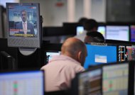 A broker monitors market movements at the BGC Partners firm in London, August 2011. European stocks and the euro rose further after the ECB moved to boost lending and Spanish borrowing costs dropped, easing tensions over the eurozone debt crisis