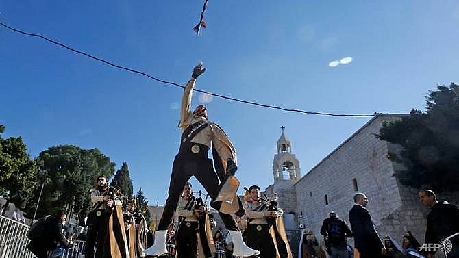 pilgrims gather in bethlehem to celebrate christmas eve